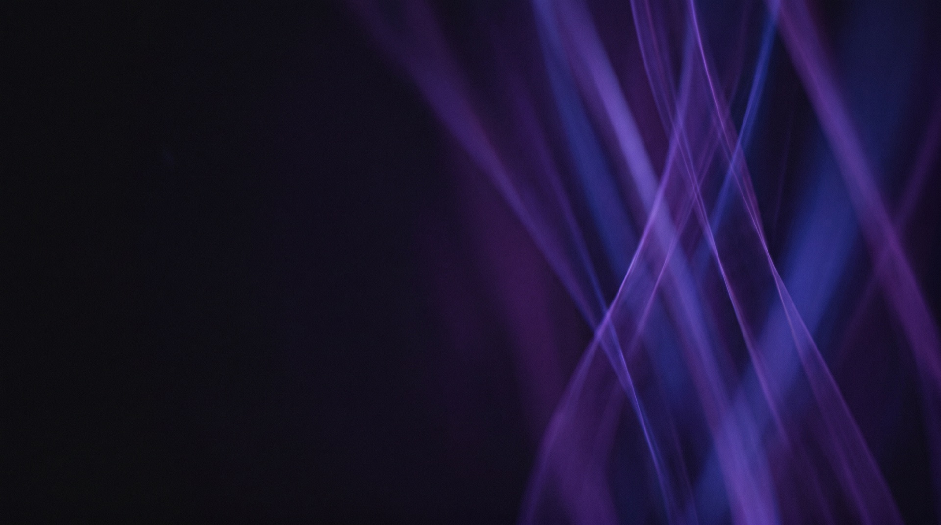 Abstract violet light streams on a dark background